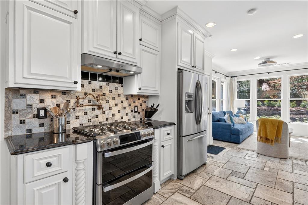 1197 Beech Valley Road Northeast Atlanta, GA 30306 - Photo 11 of 31 a kitchen with stainless steel appliances granite countertop a refrigerator stove and sink