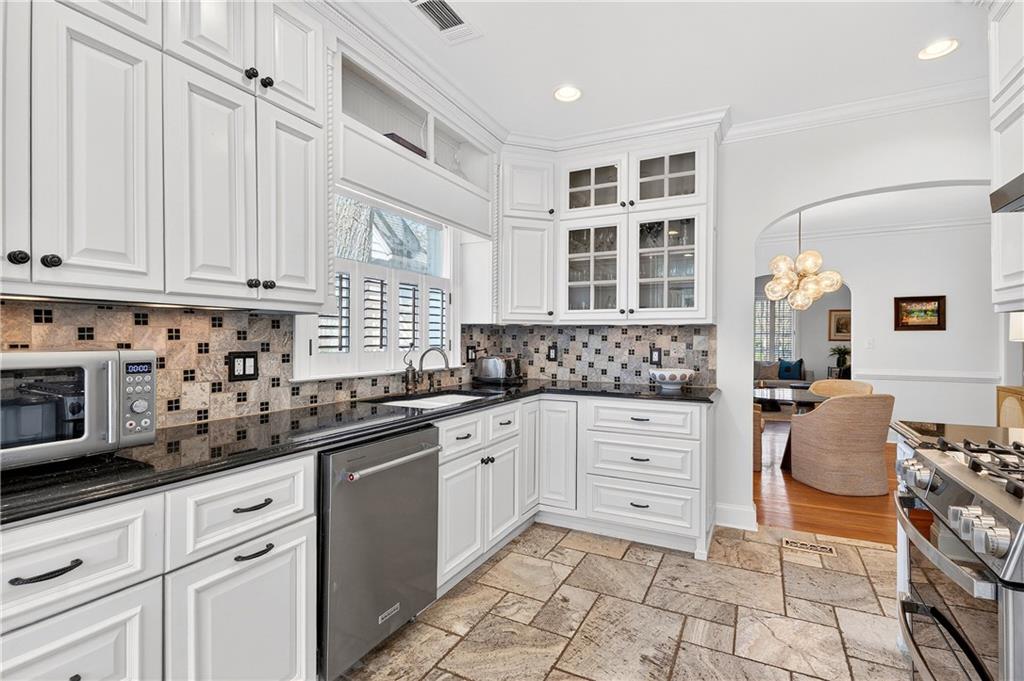 1197 Beech Valley Road Northeast Atlanta, GA 30306 - Photo 12 of 31 a kitchen with granite countertop a sink and cabinets