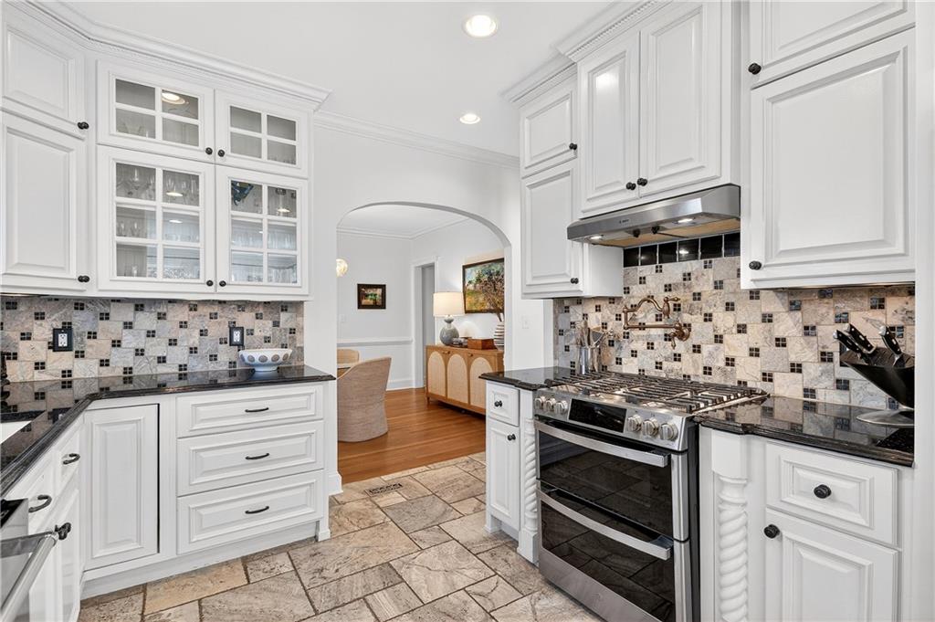 1197 Beech Valley Road Northeast Atlanta, GA 30306 - Photo 13 of 31 a kitchen with granite countertop white cabinets and stainless steel appliances