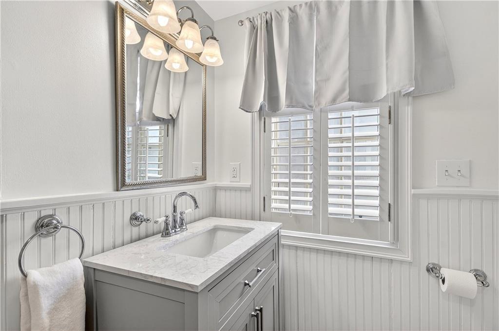 1197 Beech Valley Road Northeast Atlanta, GA 30306 - Photo 19 of 31 a bathroom with a sink vanity and a mirror