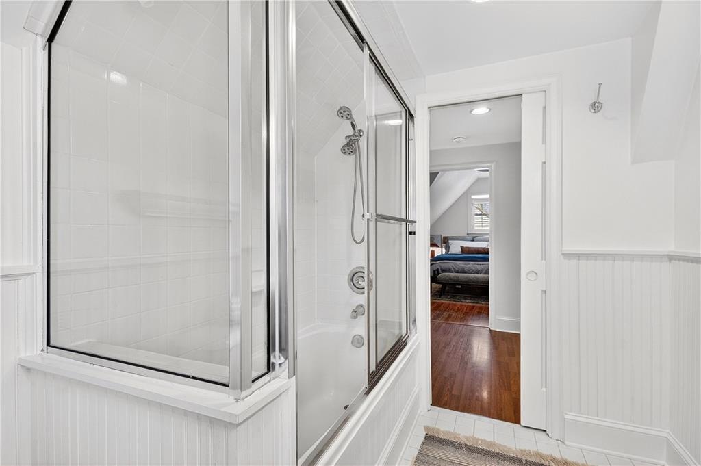 1197 Beech Valley Road Northeast Atlanta, GA 30306 - Photo 20 of 31 a bathroom with a glass shower door and a glass door