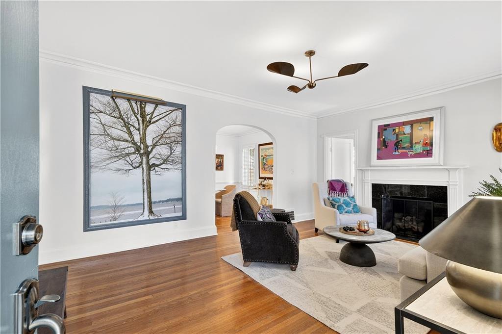 1197 Beech Valley Road Northeast Atlanta, GA 30306 - Photo 2 of 31 a living room with furniture a fireplace and a large window