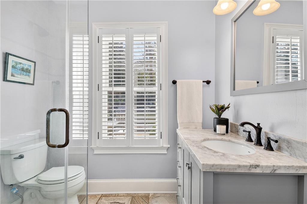 1197 Beech Valley Road Northeast Atlanta, GA 30306 - Photo 22 of 31 a bathroom with a granite countertop sink toilet and shower