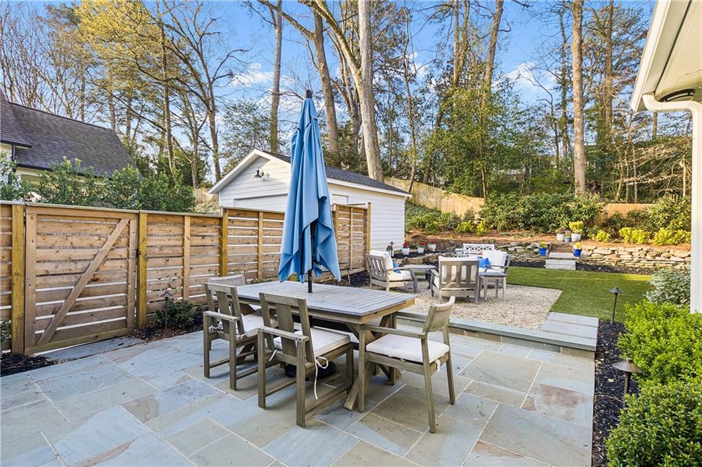 1197 Beech Valley Road Northeast Atlanta, GA 30306 - Photo 28 of 31 a view of a patio with a table and chairs