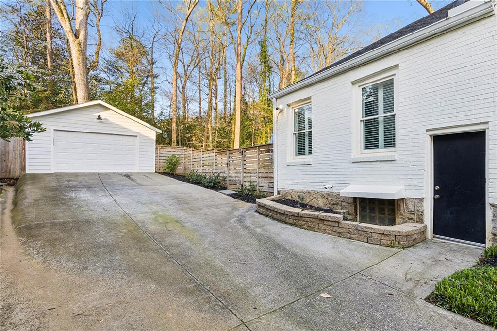 1197 Beech Valley Road Northeast Atlanta, GA 30306 - Photo 31 of 31 a front view of a house with a yard and garage