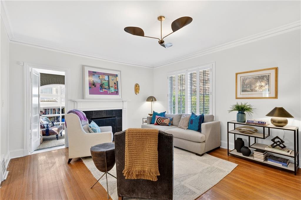 1197 Beech Valley Road Northeast Atlanta, GA 30306 - Photo 5 of 31 a living room with furniture a fireplace and a large window