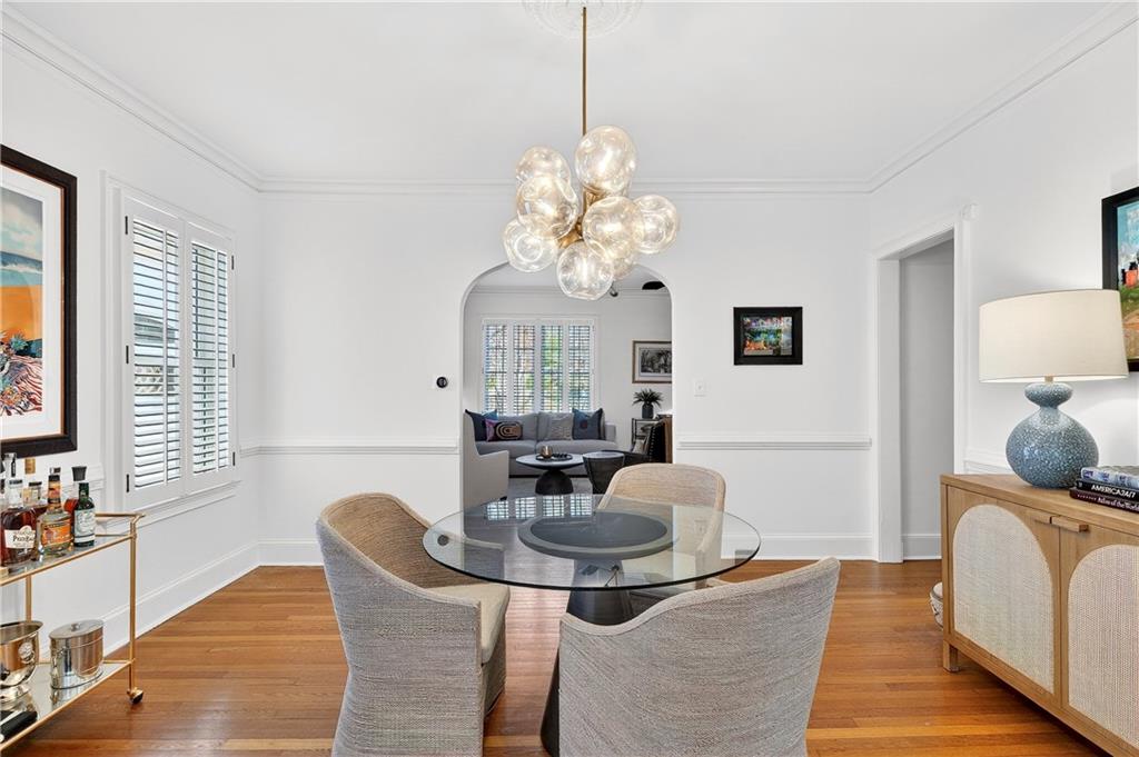 1197 Beech Valley Road Northeast Atlanta, GA 30306 - Photo 7 of 31 a dining room with chandelier and wooden floor