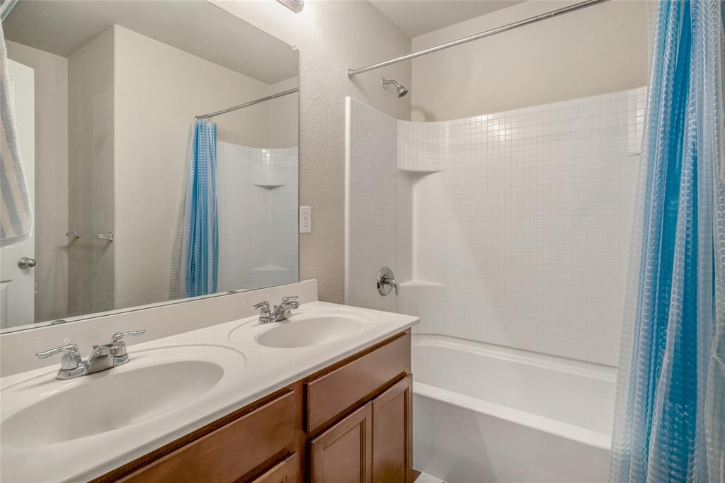 3216 Jetranger Road Fort Worth, TX 76053 - Photo 22 of 35 Full bath with shower / bathtub combination with curtain, double vanity, and a textured wall