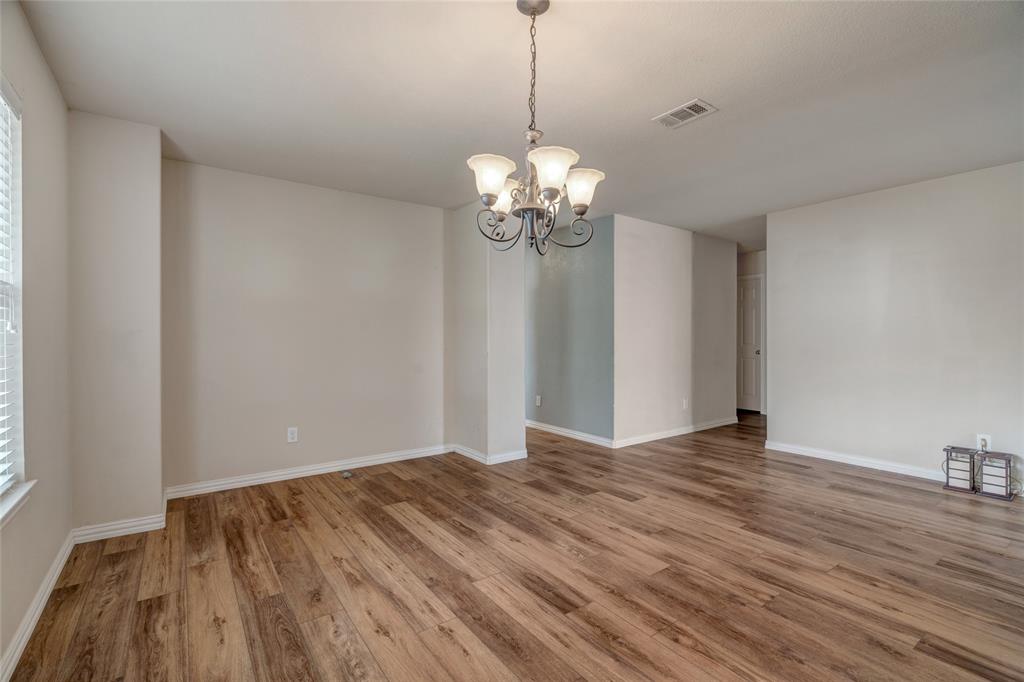 3216 Jetranger Road Fort Worth, TX 76053 - Photo 9 of 35 Spare room featuring a chandelier and wood finished floors