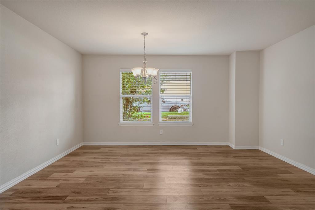 3216 Jetranger Road Fort Worth, TX 76053 - Photo 10 of 35 Unfurnished dining area with a chandelier and light wood finished floors