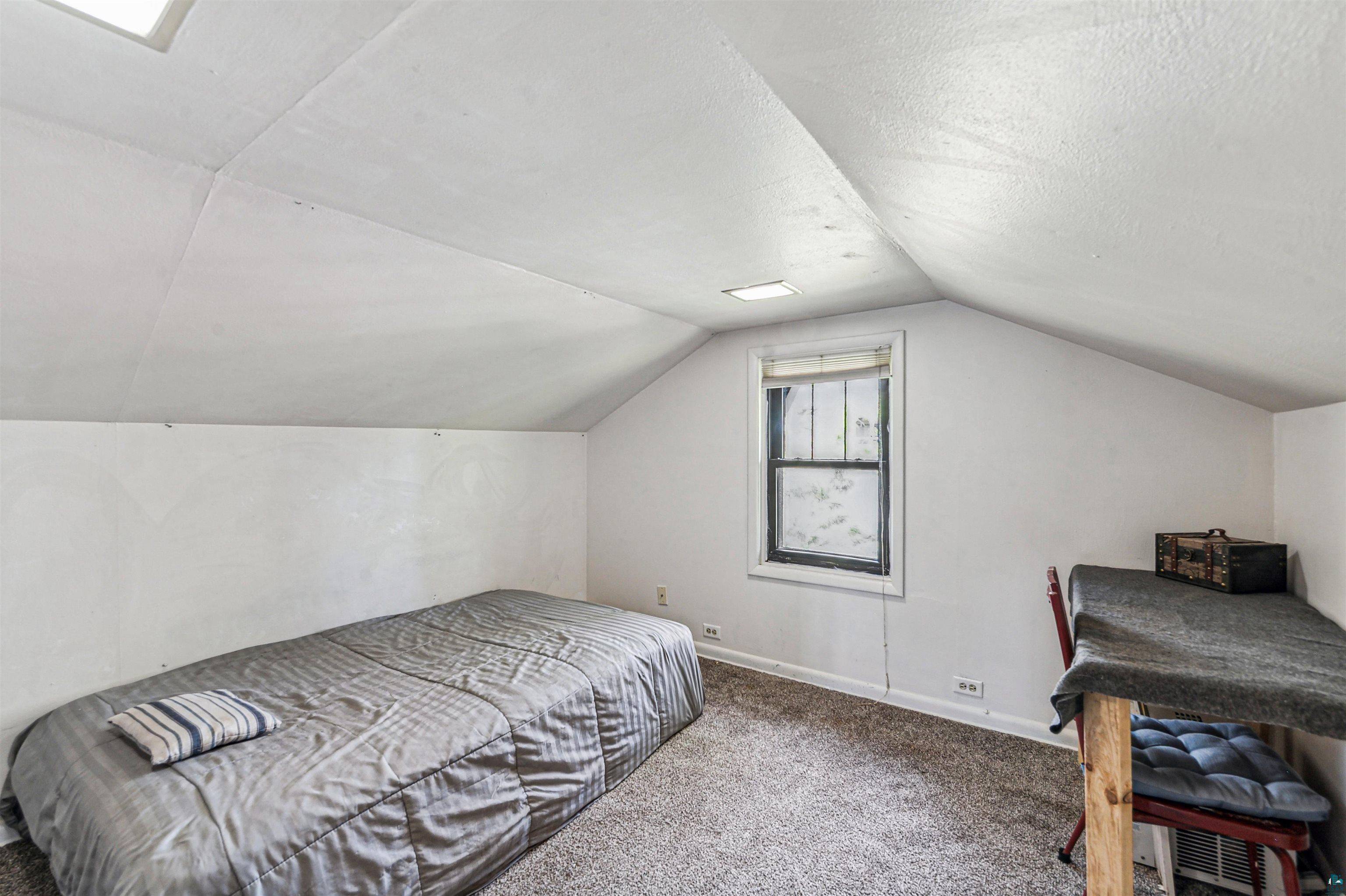 4516 Gladstone Street Duluth, MN 55804 - Photo 13 of 20 Bedroom featuring vaulted ceiling and carpet flooring