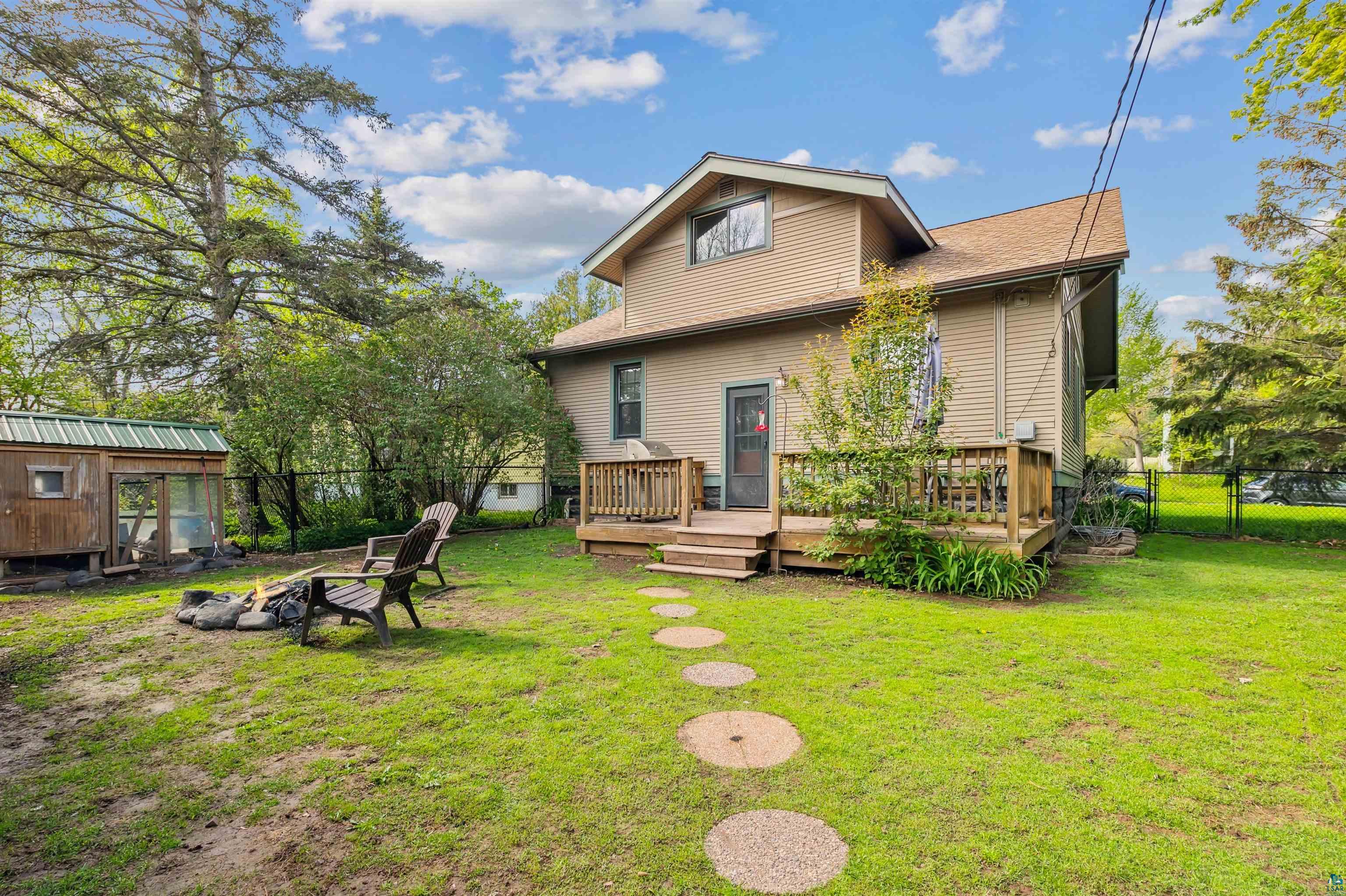 4516 Gladstone Street Duluth, MN 55804 - Photo 19 of 20 Back of property with a wooden deck, a yard, and an outdoor structure