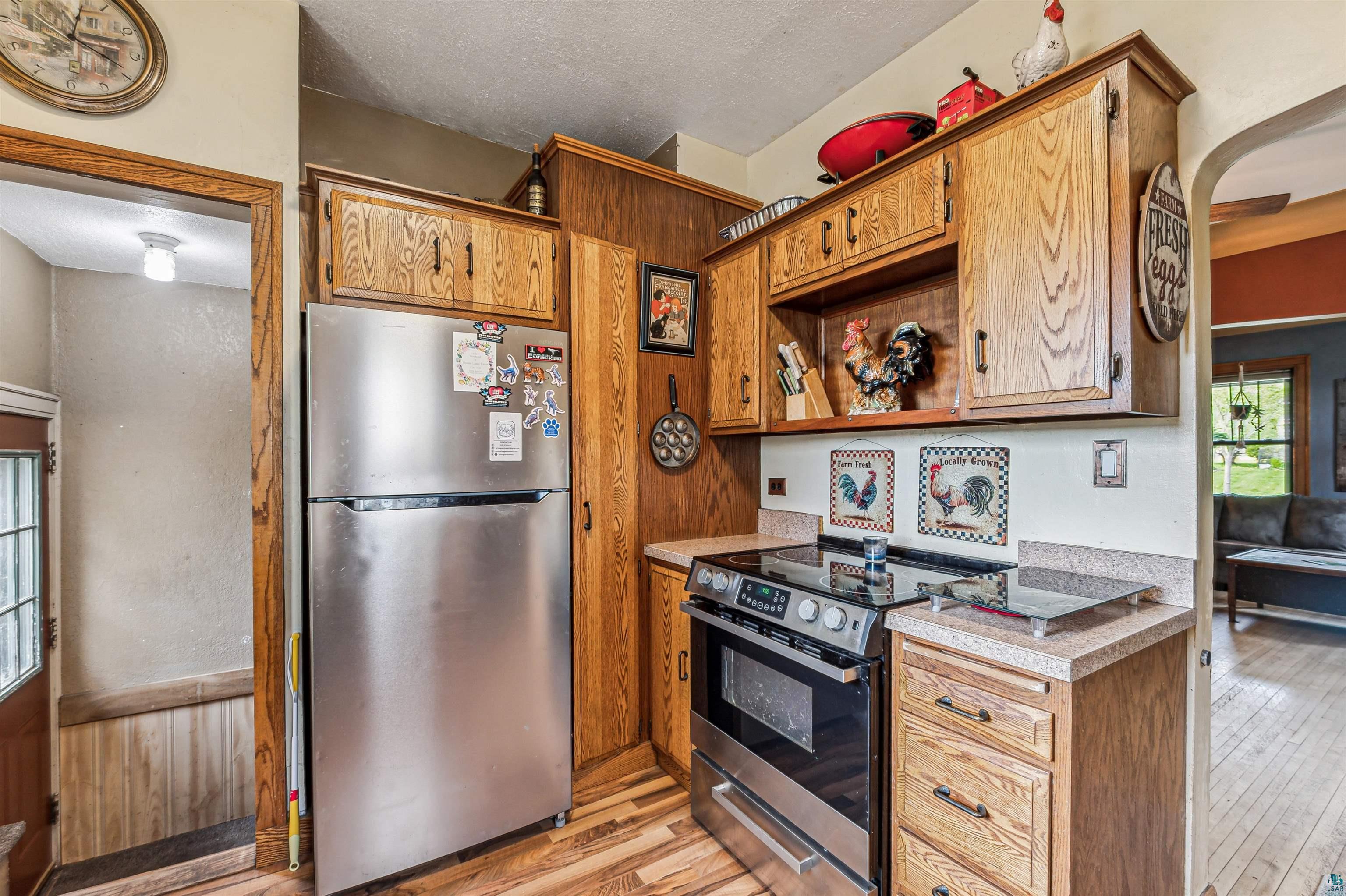 4516 Gladstone Street Duluth, MN 55804 - Photo 6 of 20 Kitchen with stainless steel appliances, light hardwood / wood-style floors, and a textured ceiling
