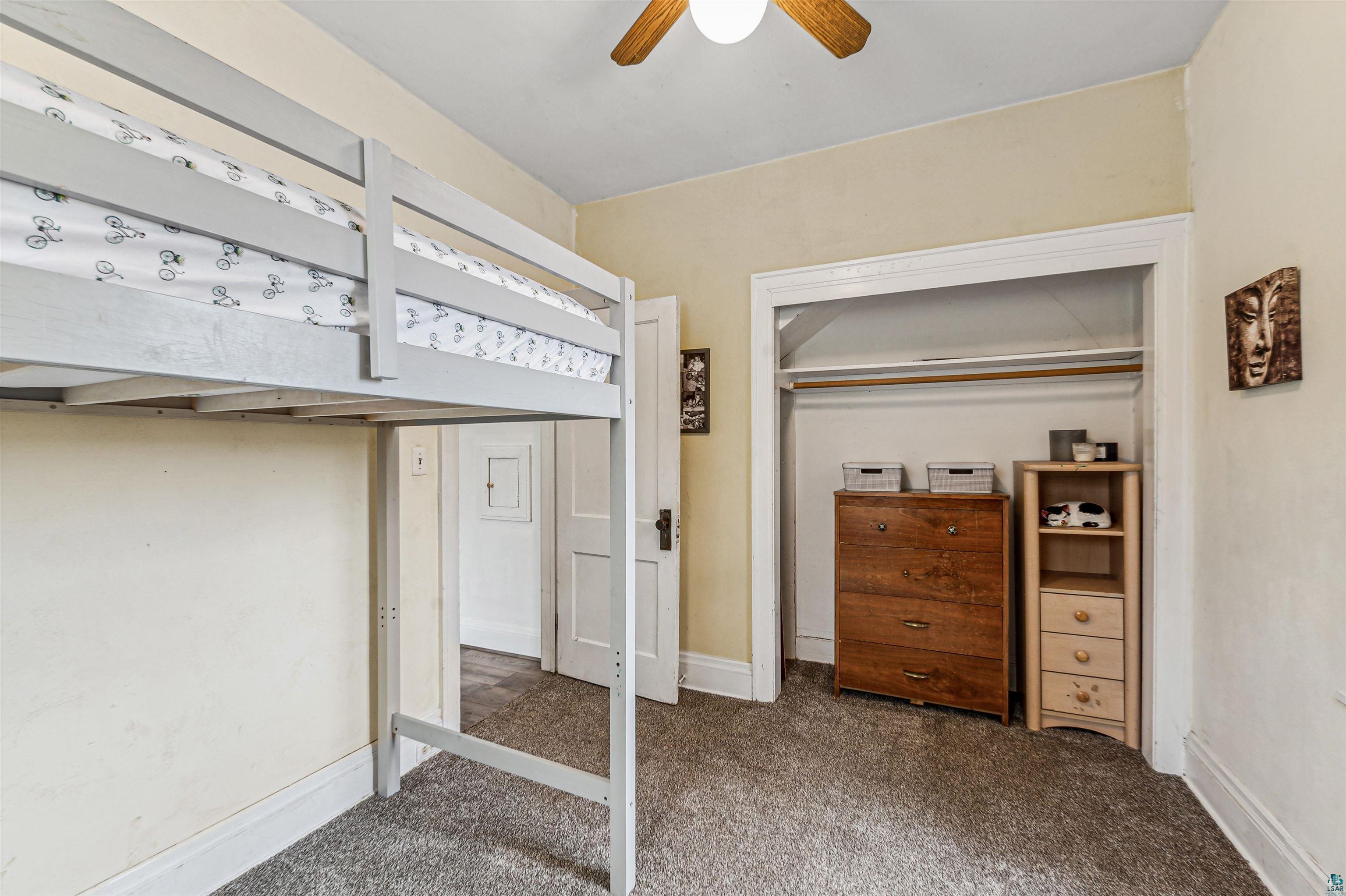 4516 Gladstone Street Duluth, MN 55804 - Photo 10 of 20 Unfurnished bedroom featuring ceiling fan, a closet, and dark carpet