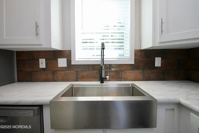 a kitchen with stainless steel appliances a refrigerator and a stove top oven