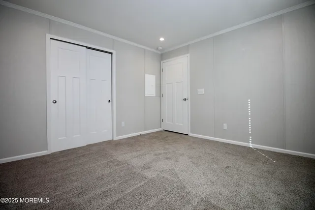 an empty room with kitchen view and a livingroom view