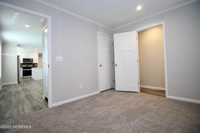 a white toilet sitting next to a white wall