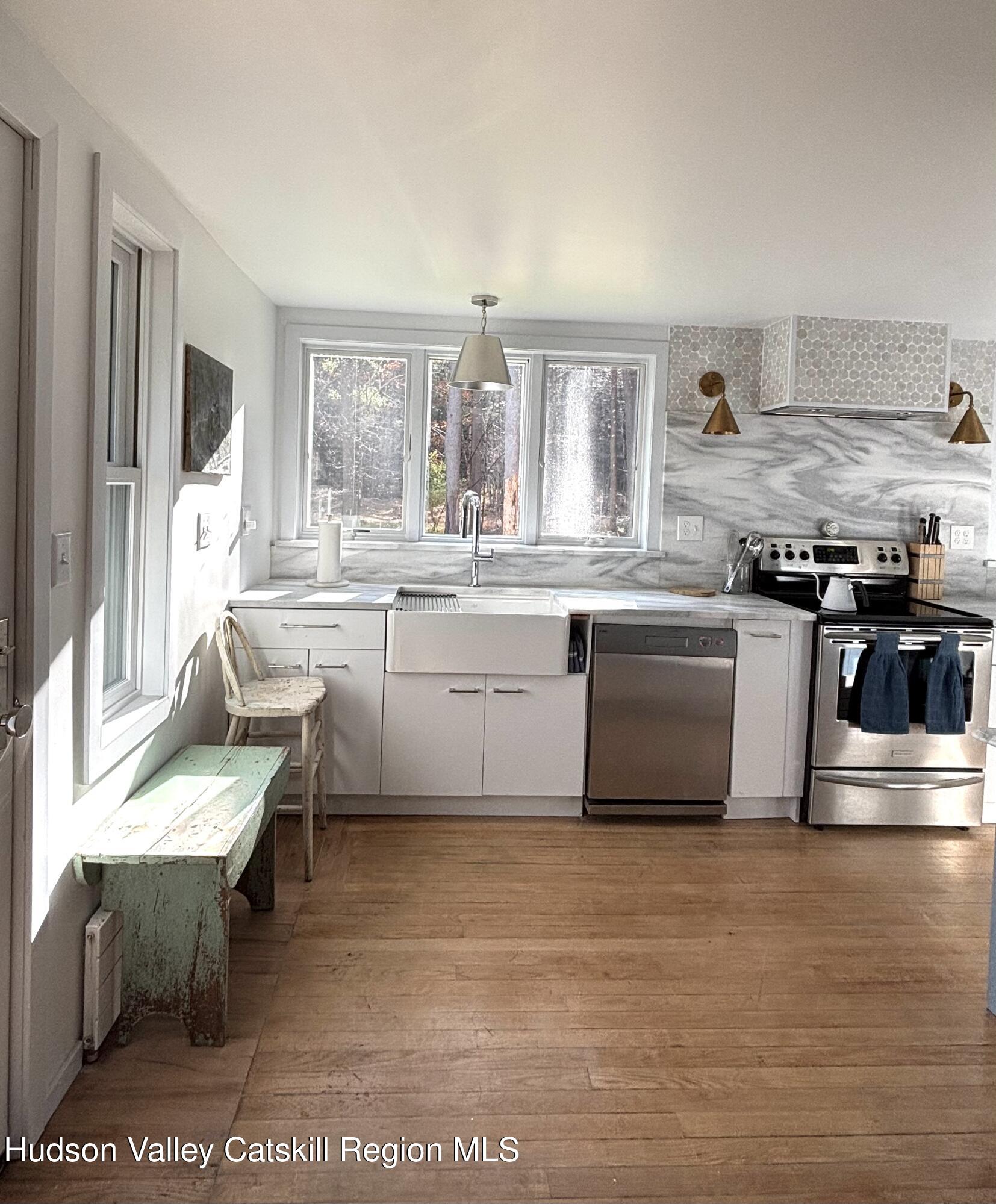 299 Wittenberg Road Woodstock, NY 12409 - Photo 13 of 49 a kitchen with stainless steel appliances granite countertop a stove a sink and a microwave