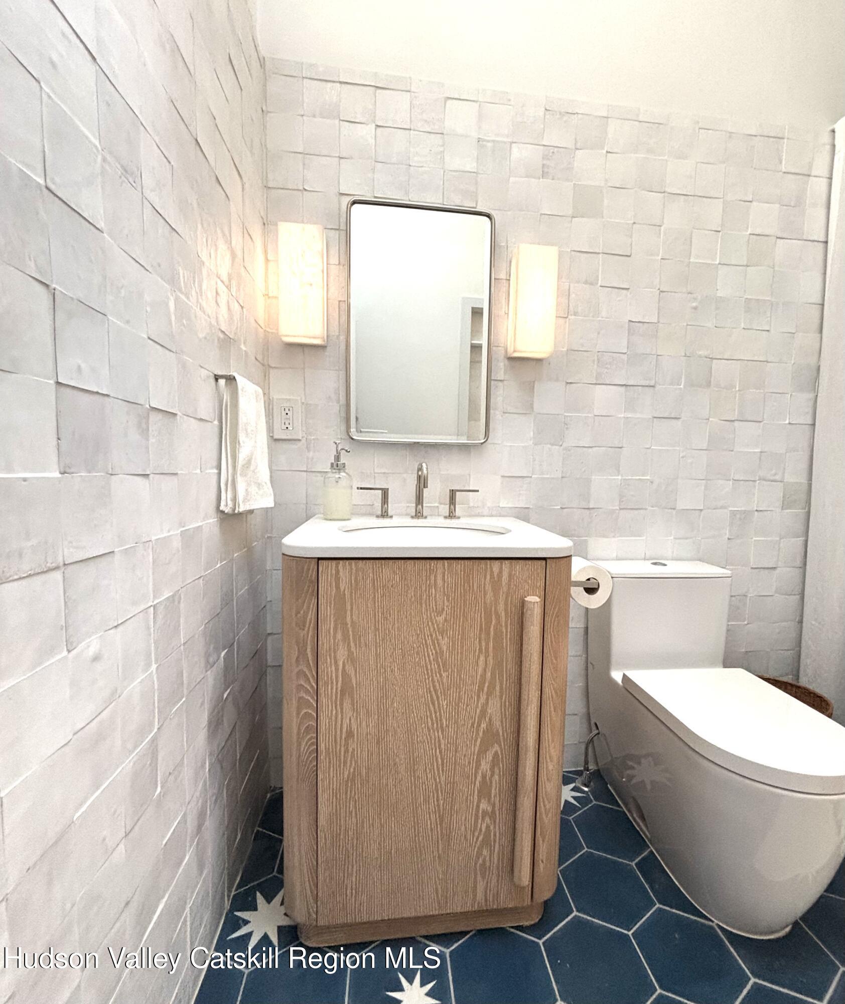 299 Wittenberg Road Woodstock, NY 12409 - Photo 35 of 49 a bathroom with a sink toilet and mirror