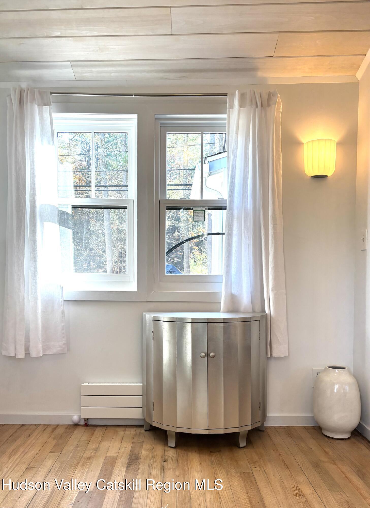 299 Wittenberg Road Woodstock, NY 12409 - Photo 38 of 49 a living room with wooden floor and a window