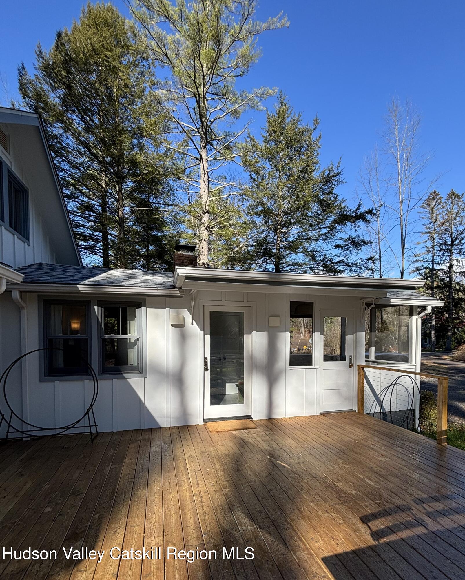 299 Wittenberg Road Woodstock, NY 12409 - Photo 49 of 49 a view of a patio with table and chairs with wooden floor and fence