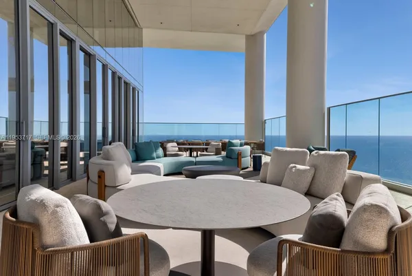 a living room with furniture and a floor to ceiling window