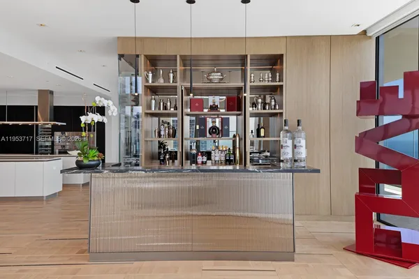 a kitchen with stainless steel appliances kitchen island wooden floors