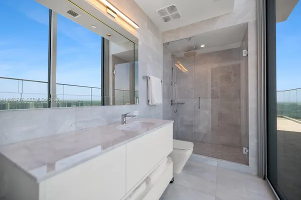 a view of living room kitchen and entryway