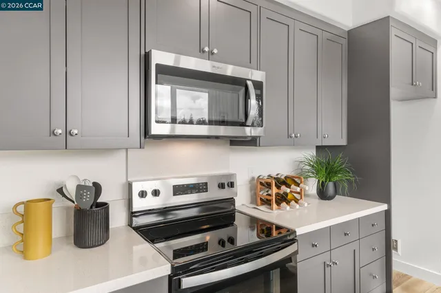 a kitchen with a stove microwave and cabinets
