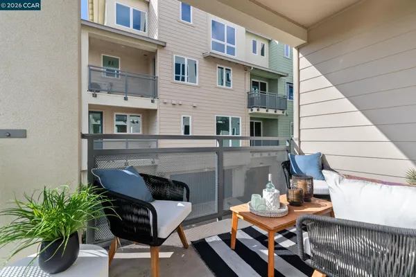 a balcony with furniture and a potted plant