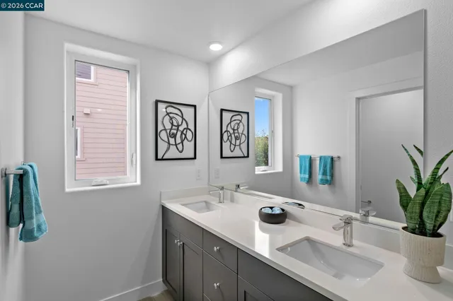 a bathroom with a double vanity sink and a mirror