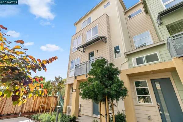 a front view of a multi story residential apartment building with yard and entryway