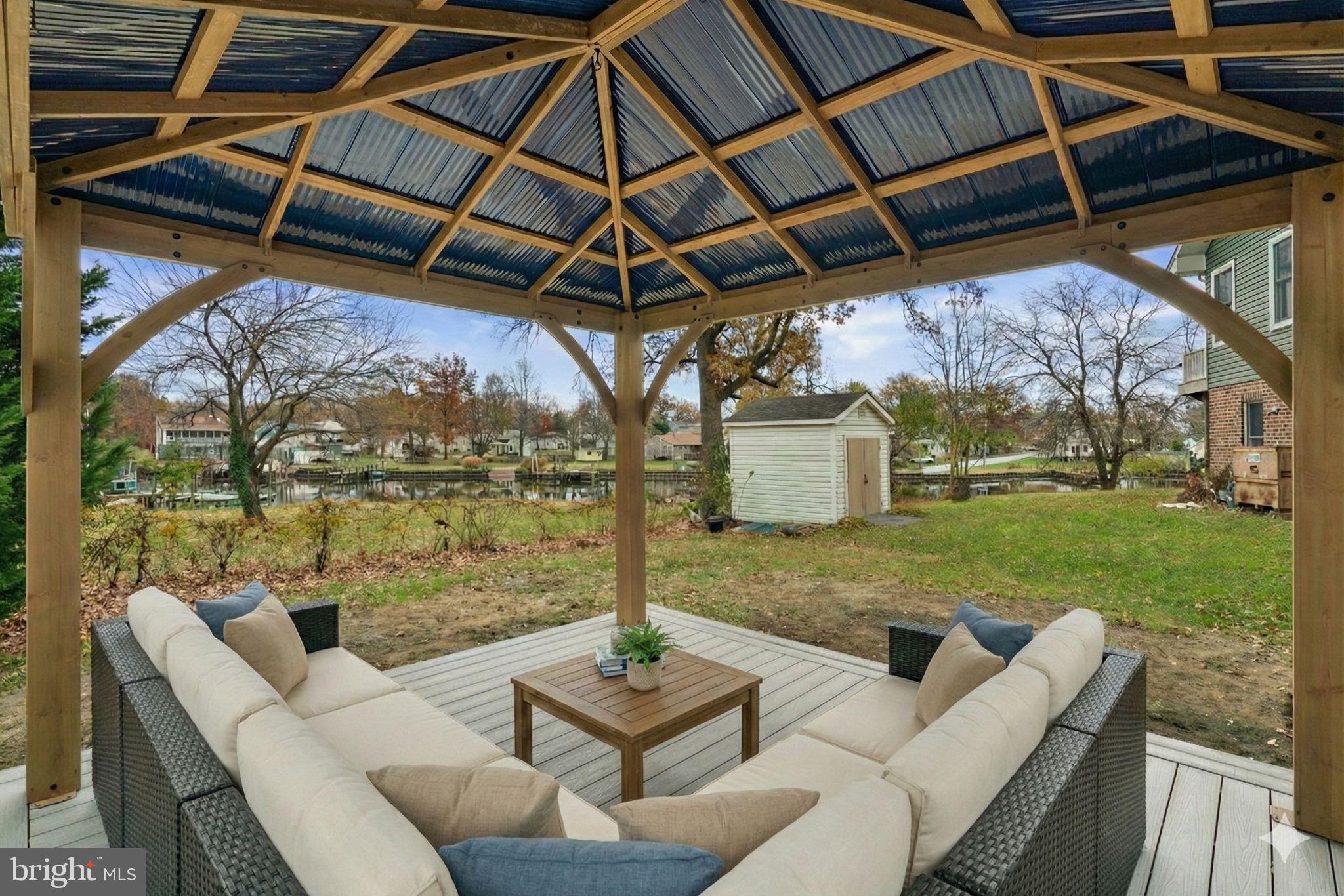 a view of a patio with couches chairs and a yard
