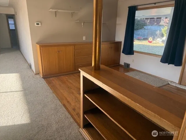 a view of hallway with a flat screen tv and a floor to ceiling window