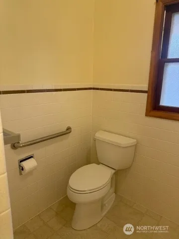 a white toilet sitting next to a shower in a bathroom