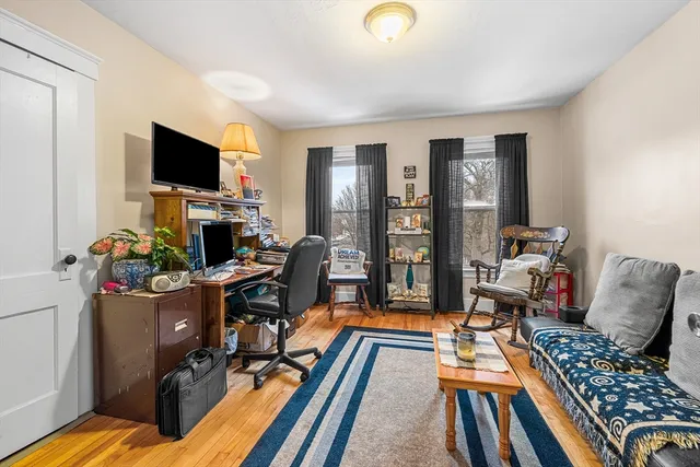 a view of a workspace with furniture and a flat screen tv