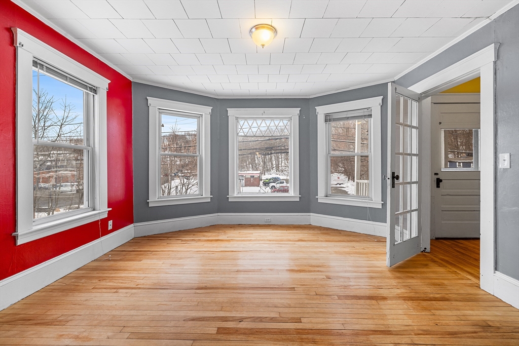 748 Water Street Fitchburg, MA 01420 - Photo 16 of 39 a view of an empty room with window and wooden floor