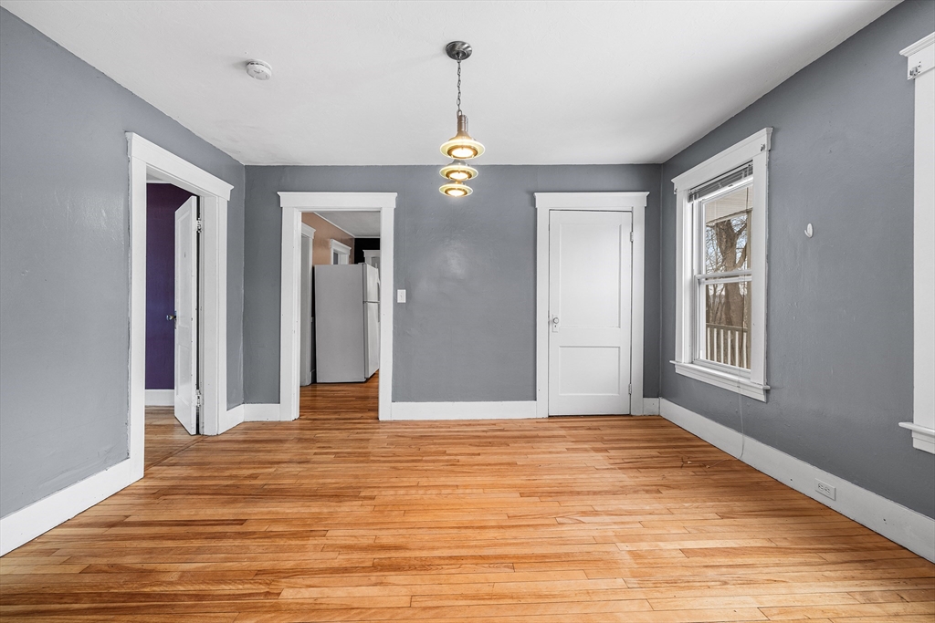 748 Water Street Fitchburg, MA 01420 - Photo 17 of 39 a view of an empty room with wooden floor and windows