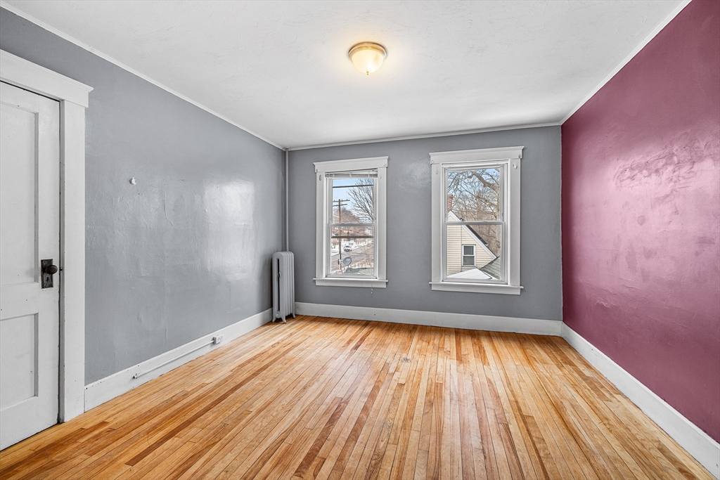 748 Water Street Fitchburg, MA 01420 - Photo 19 of 39 wooden floor in an empty room with a window