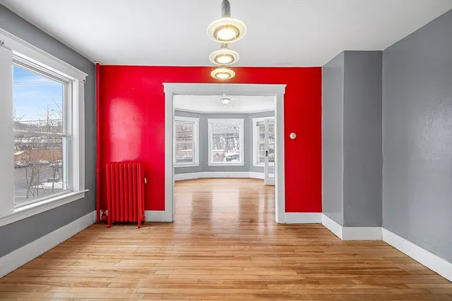 a view of a room with wooden floor and window