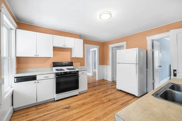 a kitchen with a sink a refrigerator and a stove