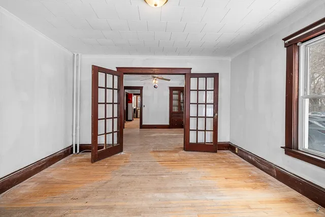 wooden floor in an empty room with a window