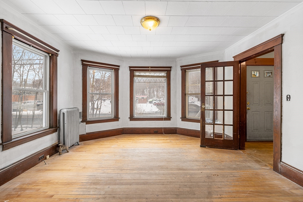 748 Water Street Fitchburg, MA 01420 - Photo 30 of 39 a view of an empty room with glass door and wooden floor