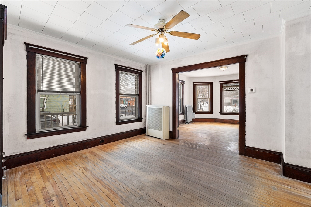 748 Water Street Fitchburg, MA 01420 - Photo 32 of 39 a view of an empty room with a window and wooden floor