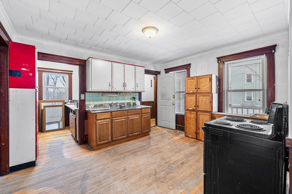 748 Water Street Fitchburg, MA 01420 - Photo 33 of 39 a kitchen with stainless steel appliances granite countertop a refrigerator a stove a sink dishwasher and a refrigerator