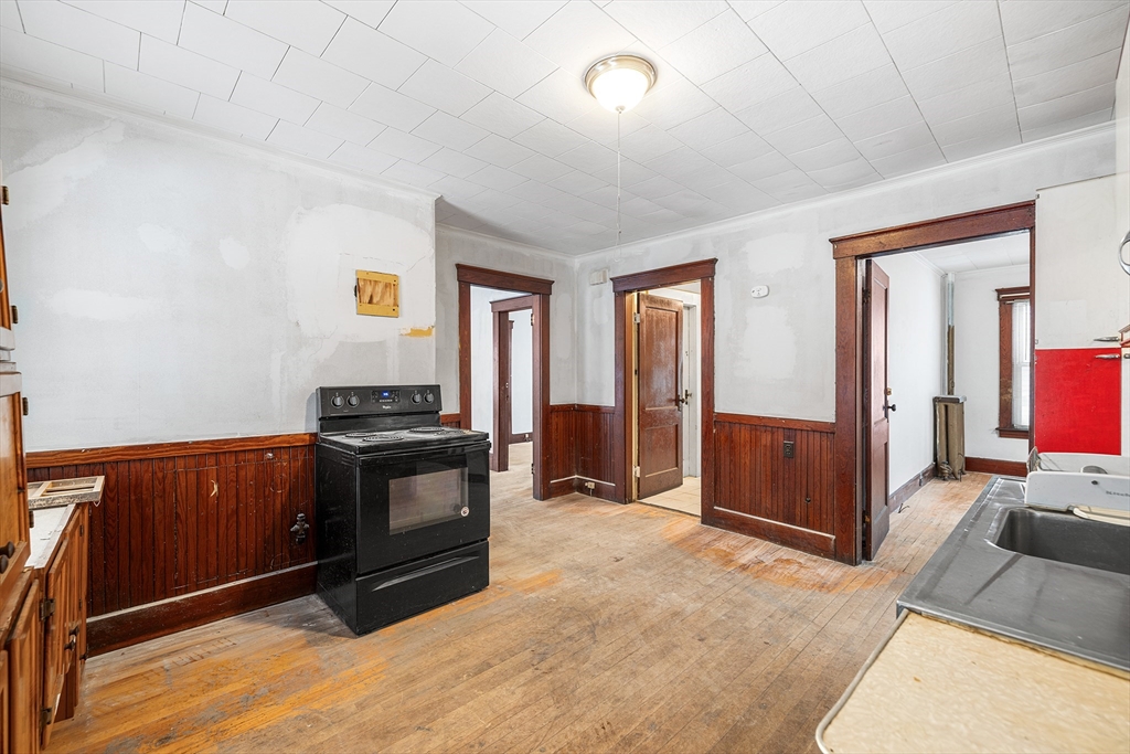 748 Water Street Fitchburg, MA 01420 - Photo 34 of 39 a kitchen with granite countertop a stove and a refrigerator