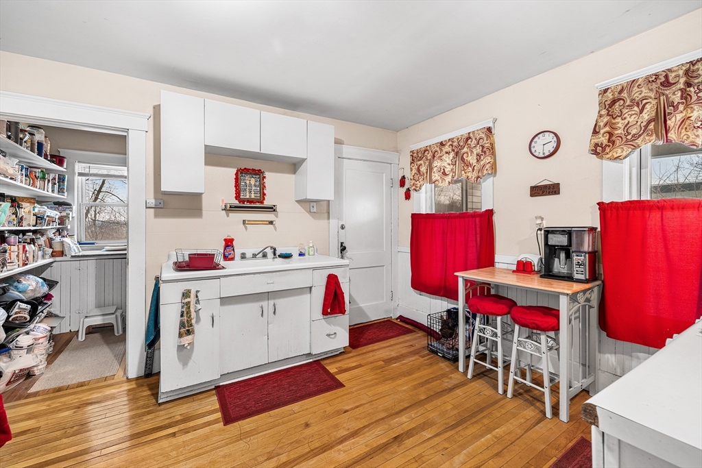 748 Water Street Fitchburg, MA 01420 - Photo 4 of 39 a living room with kitchen furniture and wooden floor