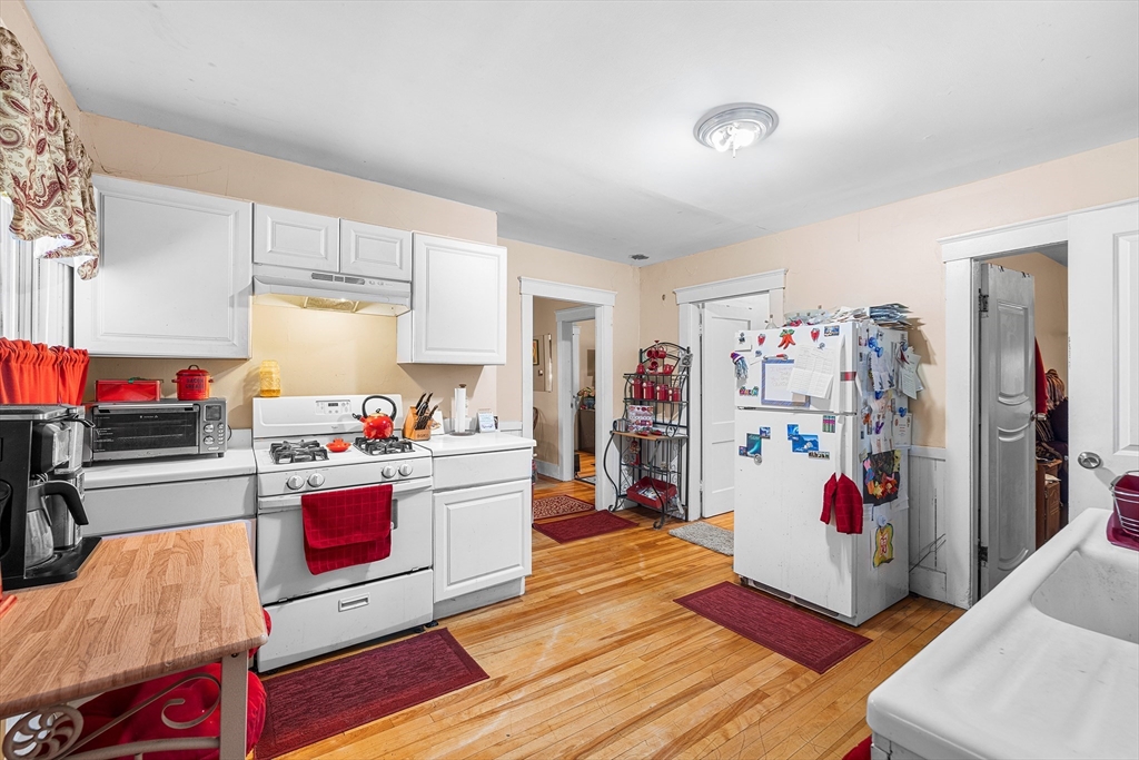 748 Water Street Fitchburg, MA 01420 - Photo 5 of 39 a kitchen with granite countertop stainless steel appliances and wooden floor