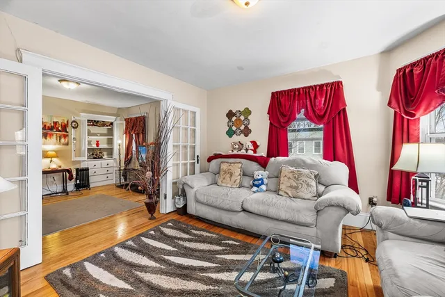 a living room with furniture a rug and a window