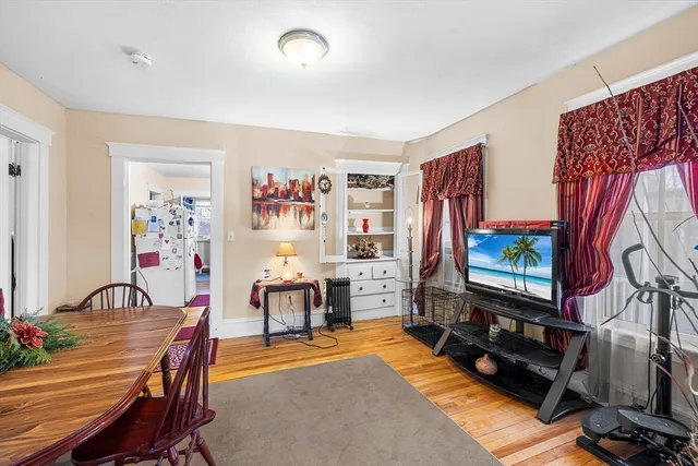 a view of a livingroom with furniture workspace and a window